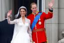 Prince William and his wife Kate wave to the crowds from the balcony of Buckingham Palace following their wedding at Westminster Abbey (PA)
