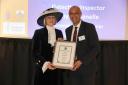 Detective Inspector Tony Fontenelle receiving the award from the High Sheriff for Hertfordshire Liz Green.