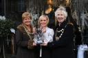Deryane Tadd, centre, receives the cup from Sandra Oldfield, left, and the mayor.