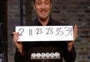 Derren Brown smiles as his prediction matches the actual lottery draw