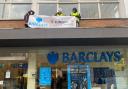 Extinction Rebellion activists on top of Barclays bank in St Albans city centre this afternoon. Credit: Brett Ellis