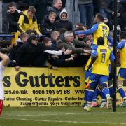 Jubilant St Albans City players celebrate Percy Kiangebeni late winner on Saturday. Picture: Leigh Page