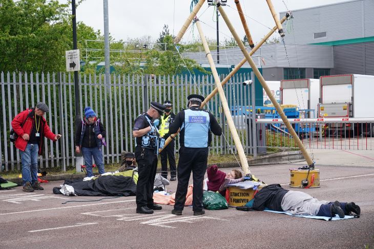 Liaison officers speak with protesters lon the ground outside the Hemel Hempstead distribution centre. Credit: PA
