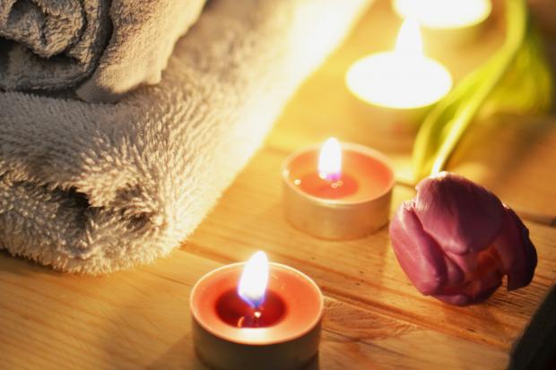 St Albans & Harpenden Review: A pile of towels, candles and a tulip. Credit: Canva