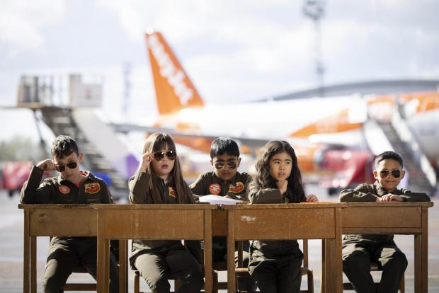 St Albans & Harpenden Review: Sam Bennett, aged 12, Olivia Joohee-Riddington, aged 9, Arjun Giri, aged 9, Rei Diec, aged 7 and Rico Jeerasinghe, aged 9 during filming of a parody of the movie Top Gun at Luton airport as part of easyJet's nextGen recruitment campaign. Credit: PA/easyJet