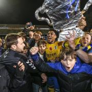 St Albans City's Shaun Jeffers celebrates with fans on the pitch after the Emirates FA Cup first round match at Clarence Park. Credit: PA