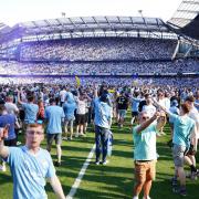 Manchester City fans invade the pitch after seeing their team clinch a fourth successive Premier League title (Martin Rickett/PA)