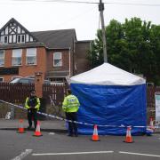 Police officers by a forensic tent at the scene of the attack in Luton (Lucy North/PA)