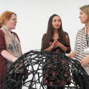 Curators Siobhan Ledden, Shannon Aherne and Inna Allen behind a sculpture by Anastasiya Kurlovich
